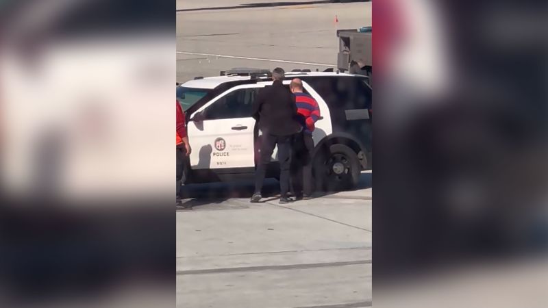 Delta passenger opens door, deploys emergency exit slide on plane at Los Angeles airport - CNN