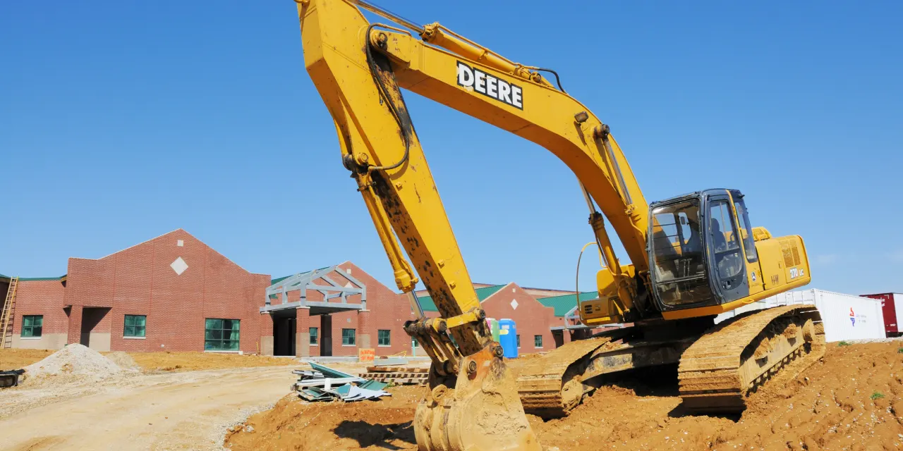Deere’s stock jumps toward another record. The construction business is booming again.