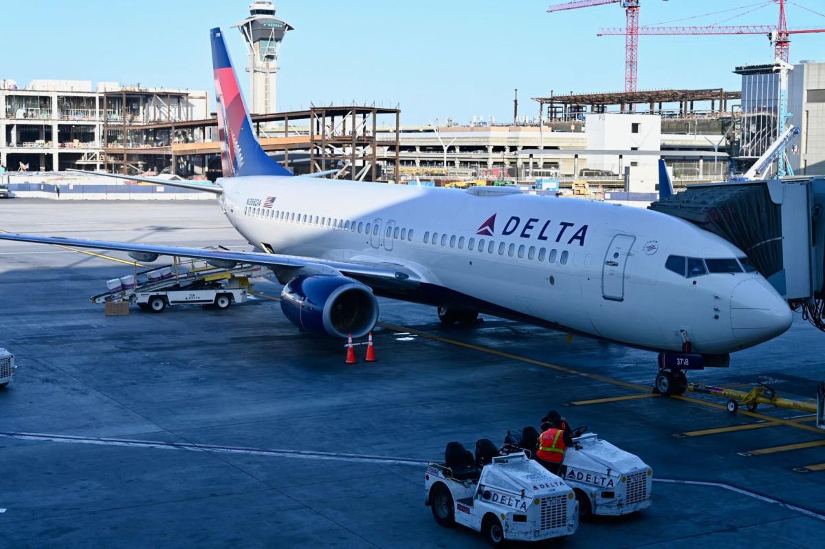 Delta passenger arrested for opening plane door then escaping down inflatable slide as plane prepared for take off - Yahoo Finance