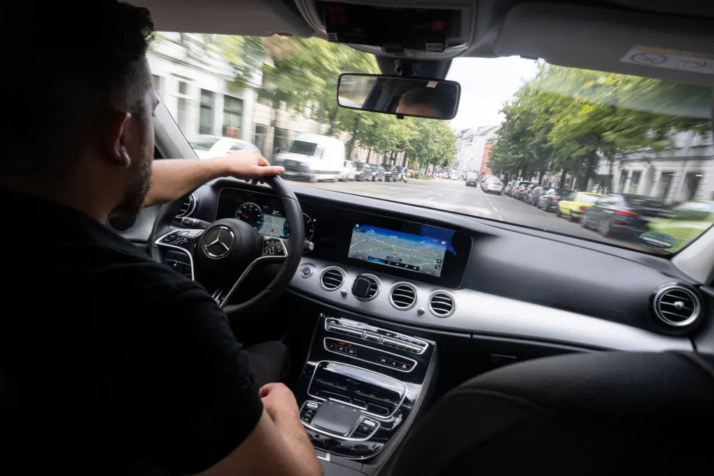 Uber's having drivers train its AI while partnering with robotaxi companies that could replace them